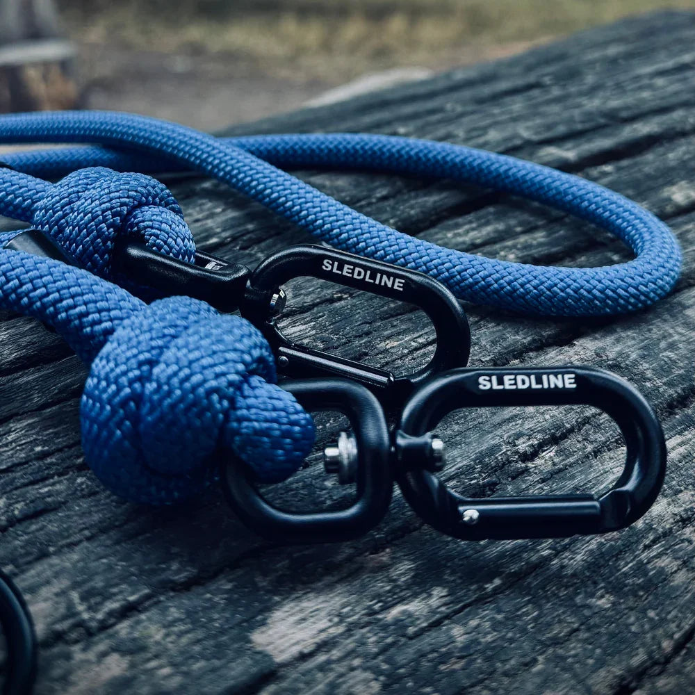 Blue rPET rope dog lead with black strength-tested hardware on wood surface