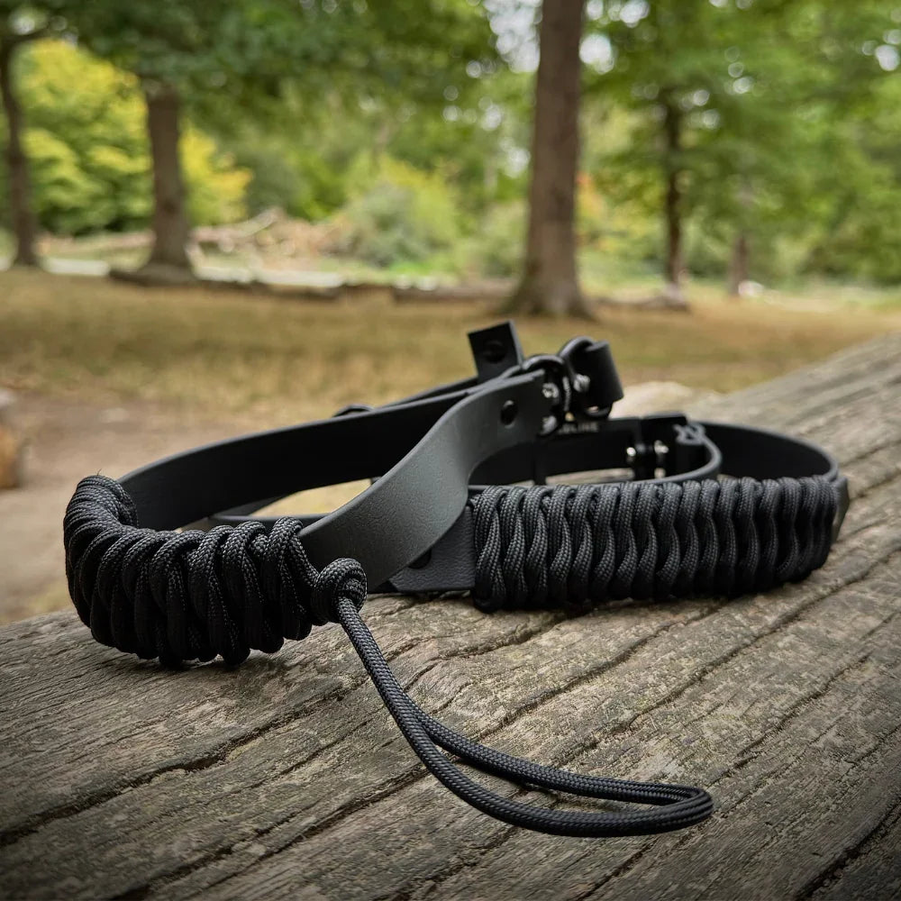 Black rPET rope and Biothane dog collar with strength tested hardware on wooden surface outdoors