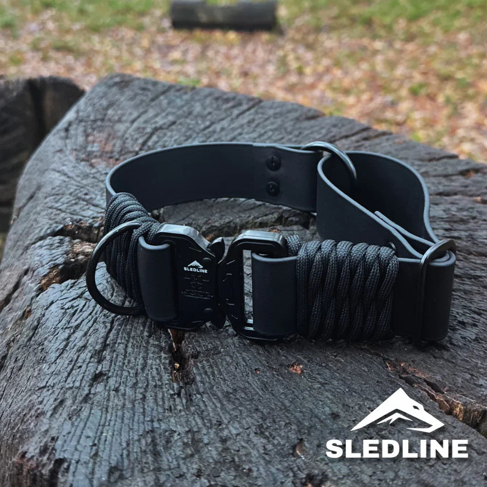 Black Biothane dog collar with rPET rope and metal hardware on a rustic wooden surface.