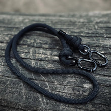 Black rPET rope dog lead with Biothane hardware on wooden surface