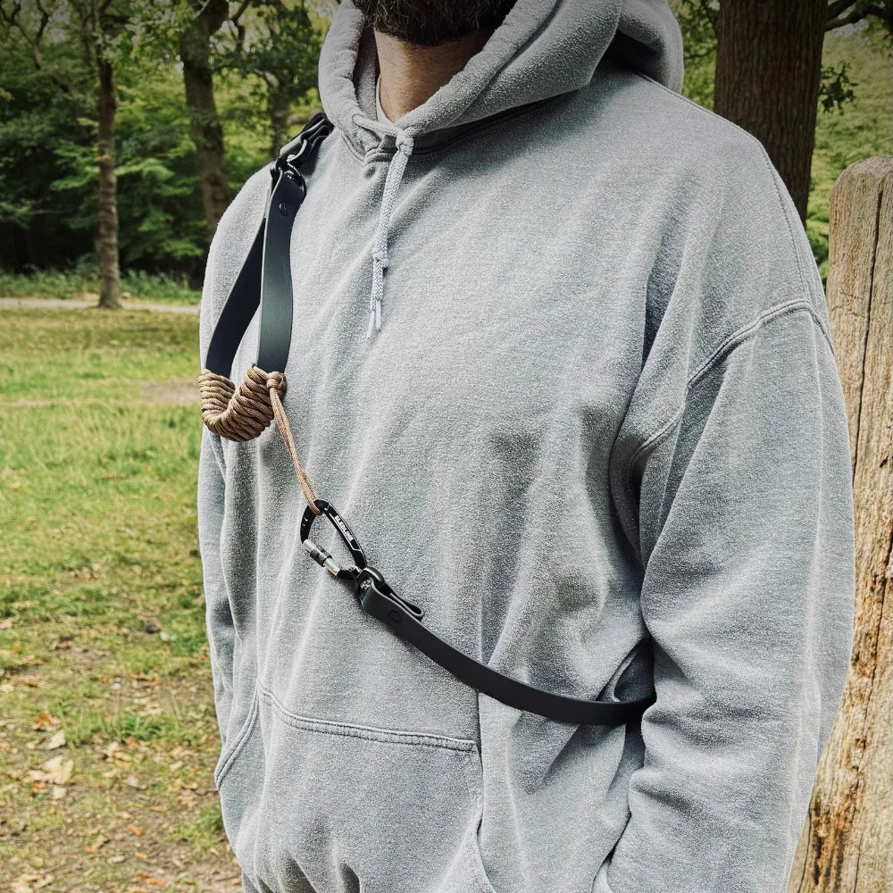 Man outdoors wearing crossbody dog lead made from rPET rope and Biothane