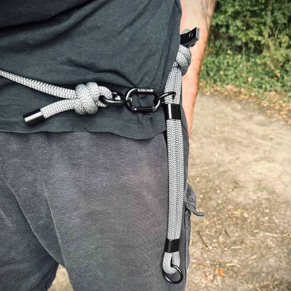 Grey rPET rope dog lead with Biothane hardware clipped to a person's waist outdoors