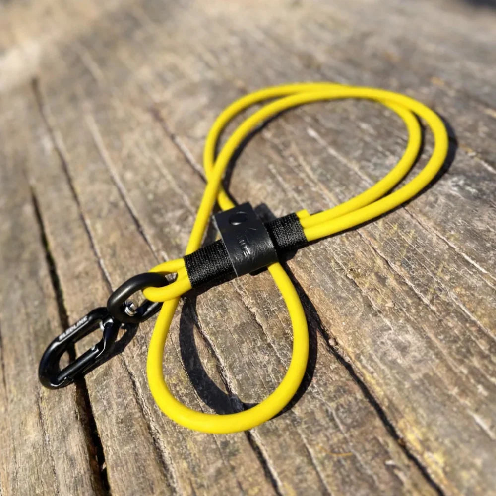Yellow rPET rope dog lead with Biothane and black hardware on wooden surface