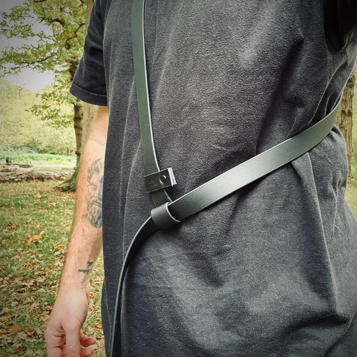 Person wearing a Biothane dog lead crossbody outdoors, premium dog lead detail shown