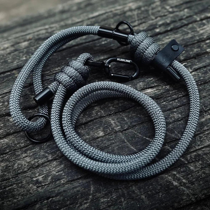 Grey rPET rope dog lead with black Biothane accents on wood surface