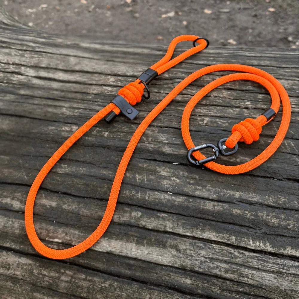 Orange rPET rope dog lead with black hardware on wooden surface