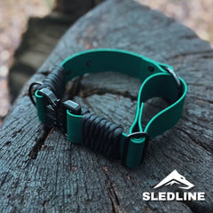 Green Biothane and rPET rope dog collar with metal clasp on wooden surface