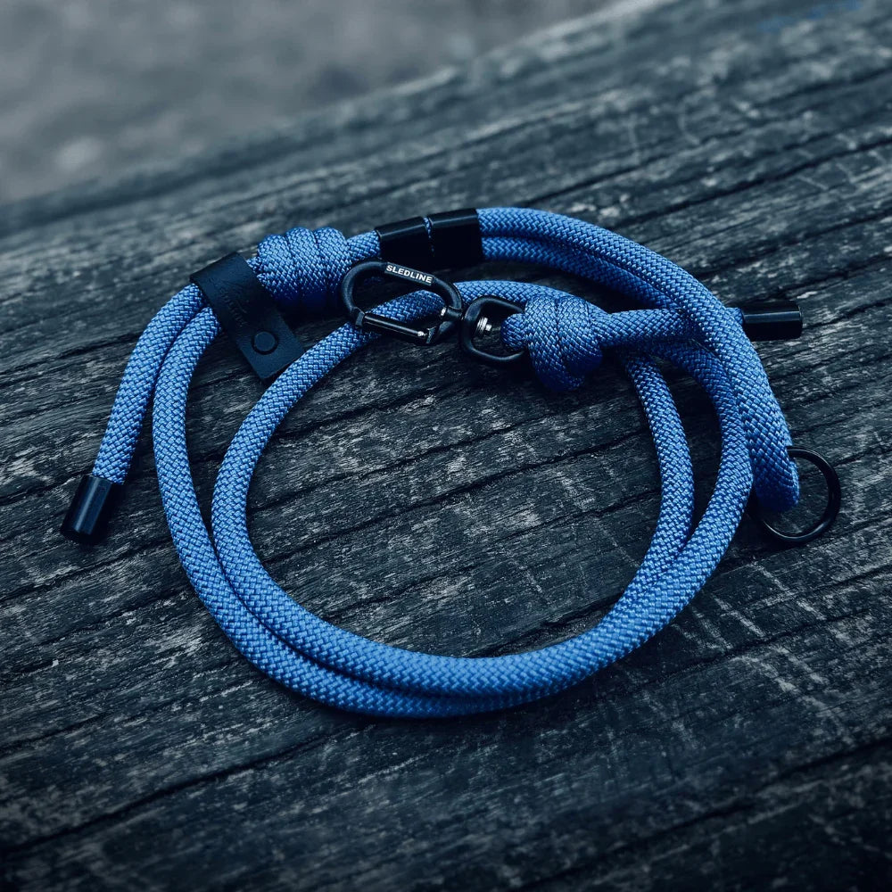 Blue rPET rope dog lead with black metal hardware on wood surface