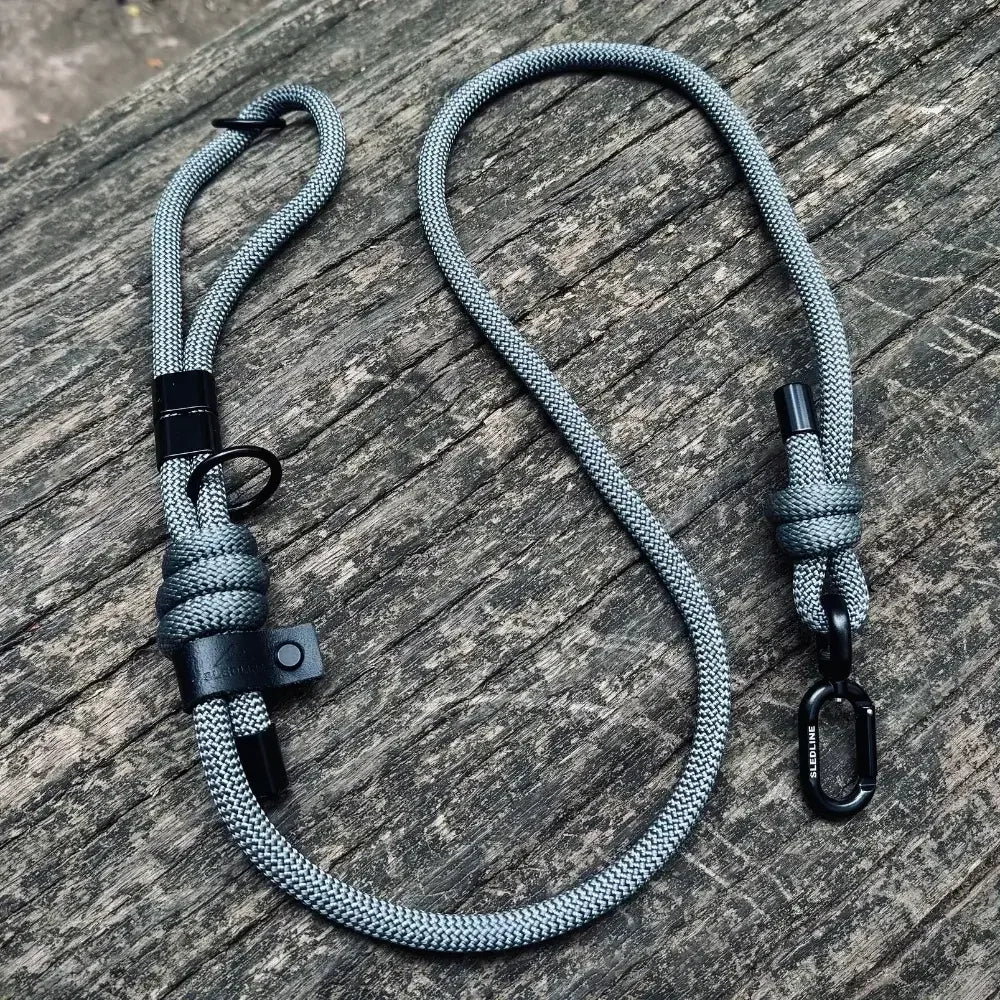 Grey rPET rope dog lead with Biothane accents and black hardware on wood surface